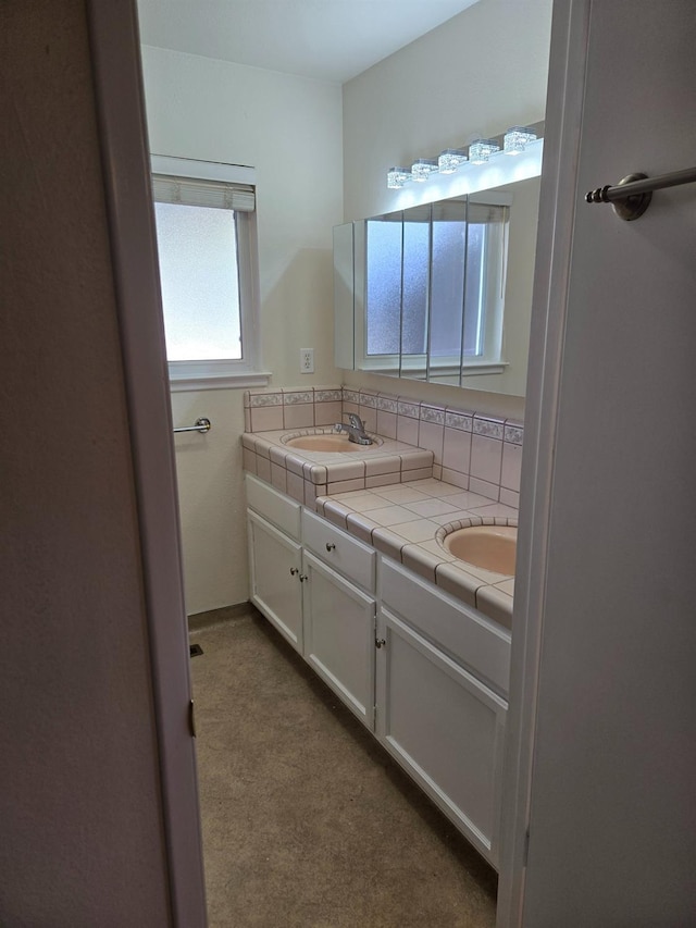 full bathroom featuring a sink, tasteful backsplash, and double vanity