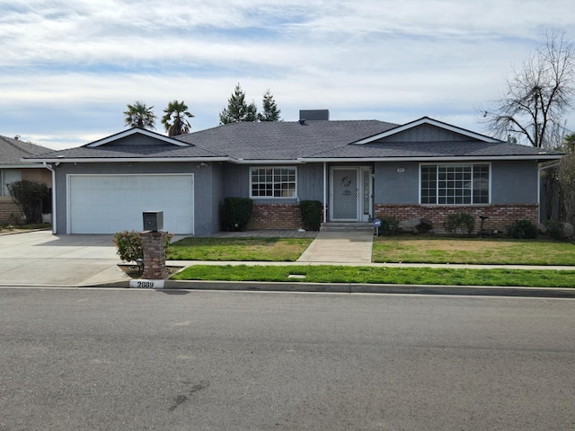 ranch-style home featuring brick siding, driveway, an attached garage, and a front yard