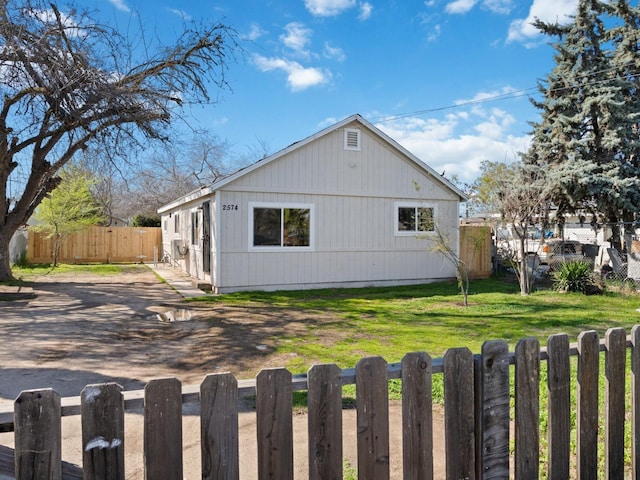 view of side of home with a yard and fence private yard