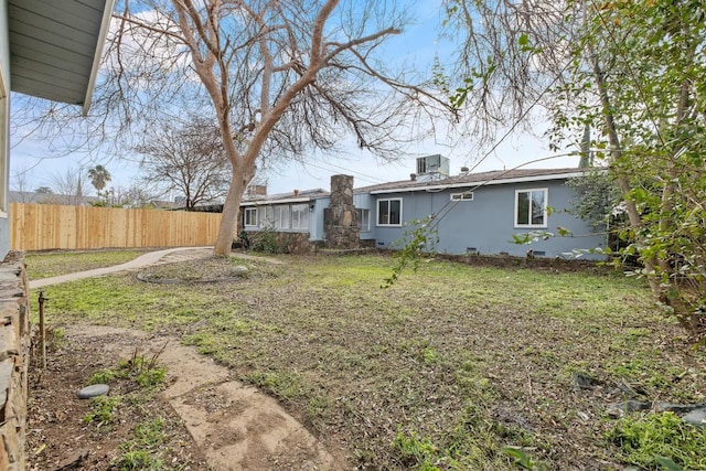 view of yard featuring central air condition unit and fence