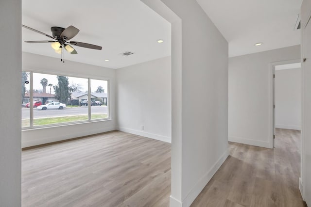 unfurnished room with visible vents, recessed lighting, baseboards, and wood finished floors