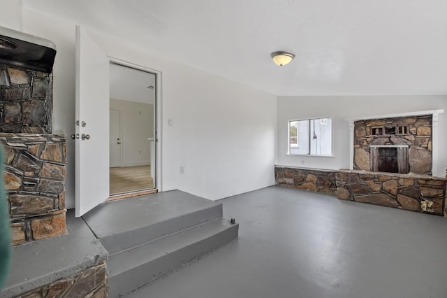 living area with finished concrete floors and lofted ceiling