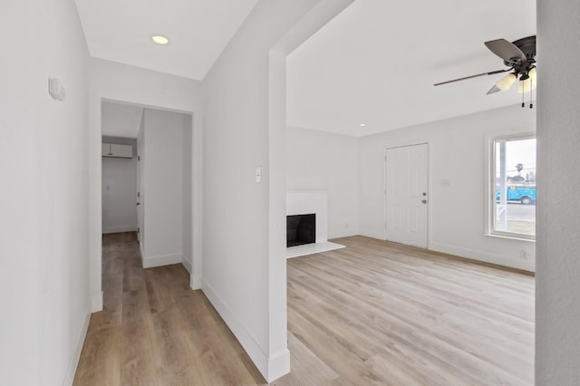 hallway with light wood-style flooring and baseboards