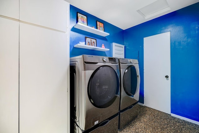 laundry room with washing machine and clothes dryer, laundry area, and attic access