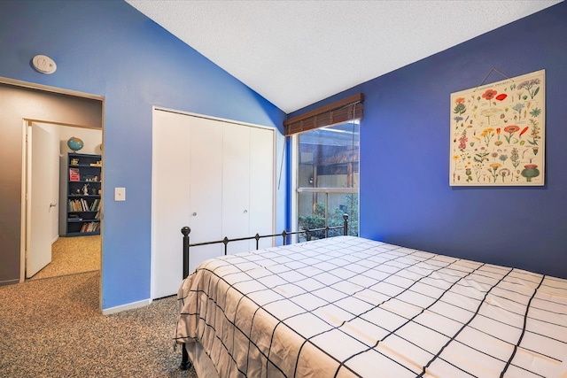 bedroom with vaulted ceiling, carpet flooring, a closet, and a textured ceiling