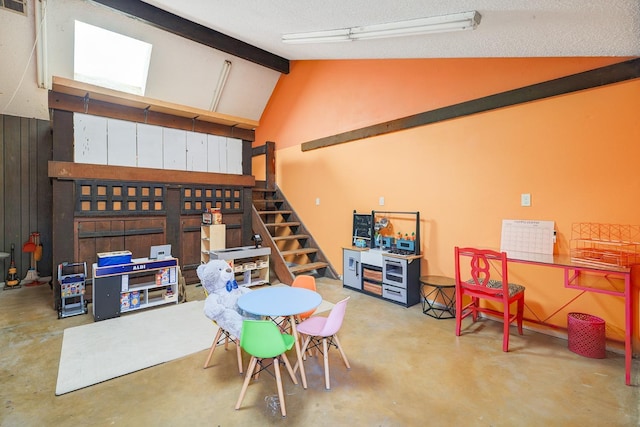 interior space featuring lofted ceiling with beams and concrete flooring