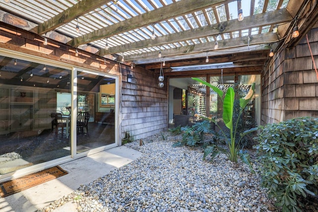 entrance to property featuring a pergola