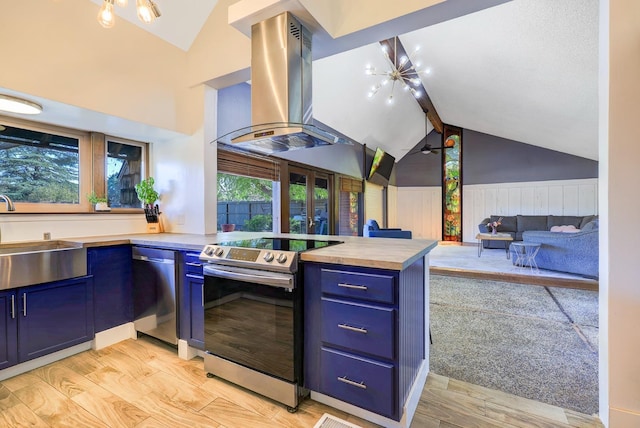 kitchen with blue cabinets, stainless steel appliances, island range hood, and a sink