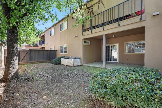 8153 N Cedar Ave Unit 106, Fresno, CA 93720 - back of house with stucco siding, a balcony, and a patio area