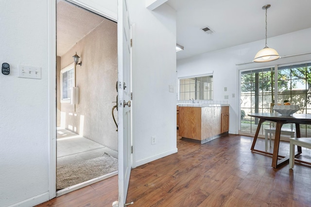 8153 N Cedar Ave Unit 106, Fresno, CA 93720 - kitchen featuring dark wood finished floors, decorative light fixtures, light countertops, baseboards, and a sink