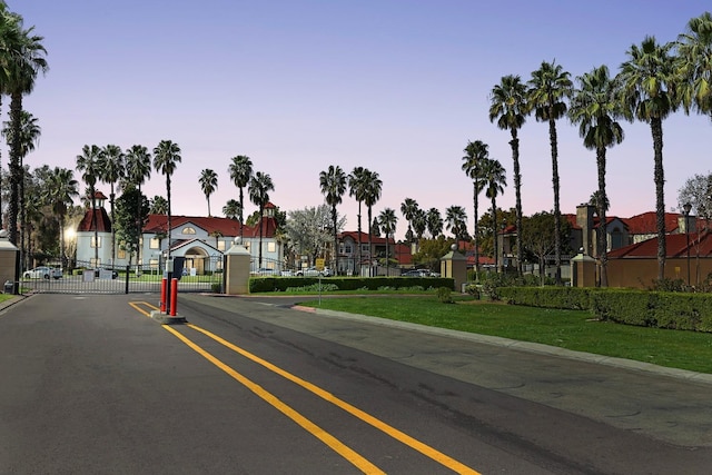 8153 N Cedar Ave Unit 106, Fresno, CA 93720 - view of asphalt road with curbs, a gate, and a residential view
