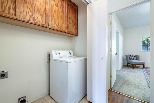 8153 N Cedar Ave Unit 106, Fresno, CA 93720 - washroom featuring washer / dryer, cabinet space, and light wood-type flooring