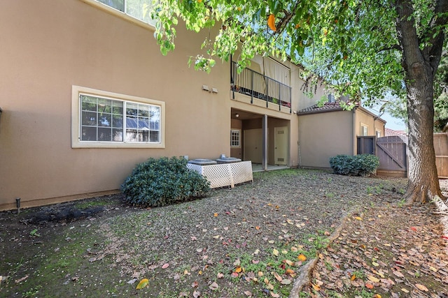 8153 N Cedar Ave Unit 106, Fresno, CA 93720 - back of house featuring a balcony, stucco siding, and a gate