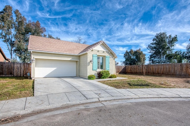 view of front of home with concrete driveway, a garage, and fence