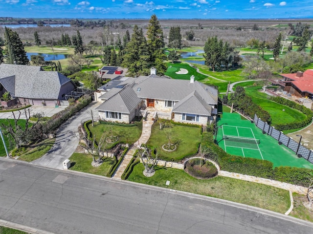 aerial view featuring golf course view and a water view