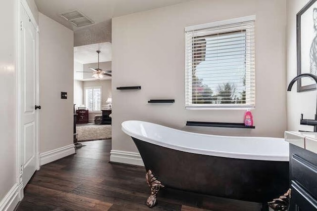 26189 Valerie Ave, Madera, CA 93638 - bathroom featuring a freestanding tub, wood finished floors, baseboards, and vanity
