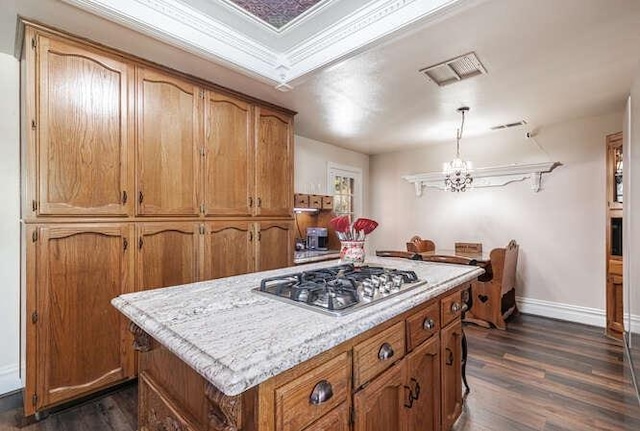 26189 Valerie Ave, Madera, CA 93638 - kitchen with stainless steel gas stovetop, dark wood-type flooring, a chandelier, and brown cabinets