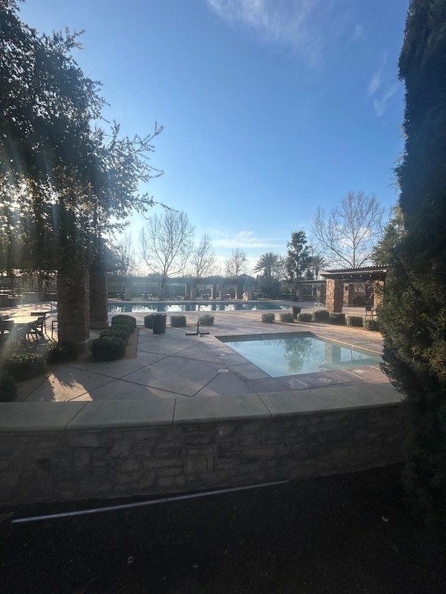 community pool with a patio area