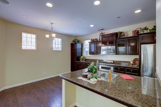 kitchen featuring visible vents, dark wood-type flooring, recessed lighting, appliances with stainless steel finishes, and a sink