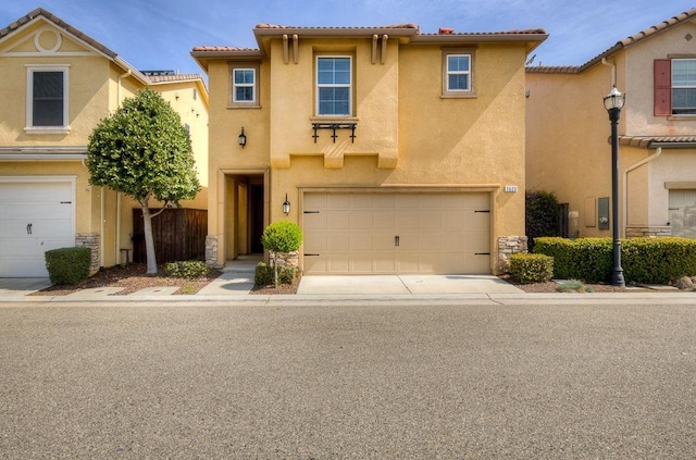 view of front facade featuring stucco siding, a garage, concrete driveway, and a tile roof