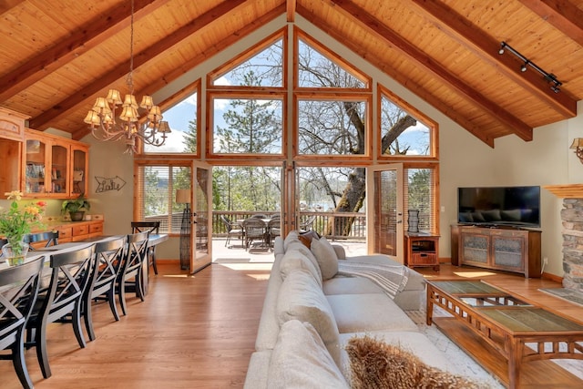 living room featuring beamed ceiling, wood ceiling, light wood-style flooring, a notable chandelier, and high vaulted ceiling