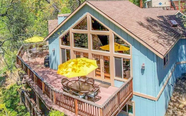 exterior space featuring french doors, a fire pit, and a deck