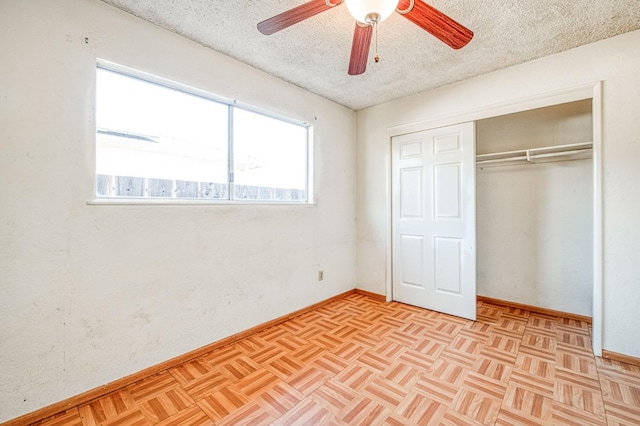 unfurnished bedroom featuring baseboards, a ceiling fan, a closet, and a textured ceiling