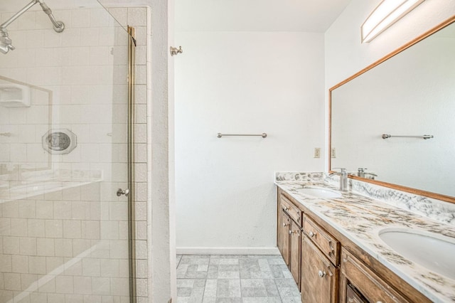 bathroom featuring a stall shower and a sink