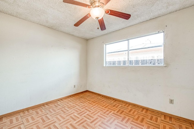 empty room featuring a ceiling fan and a textured ceiling