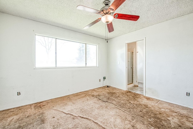 carpeted empty room featuring a textured ceiling and ceiling fan