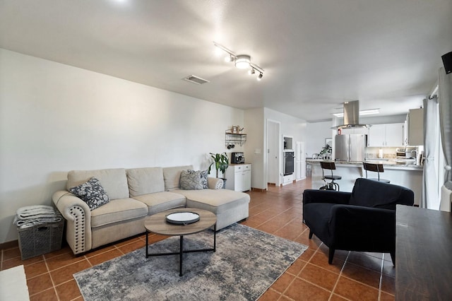 tiled living area featuring visible vents