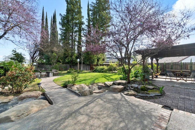 view of patio featuring a fire pit and a fenced backyard