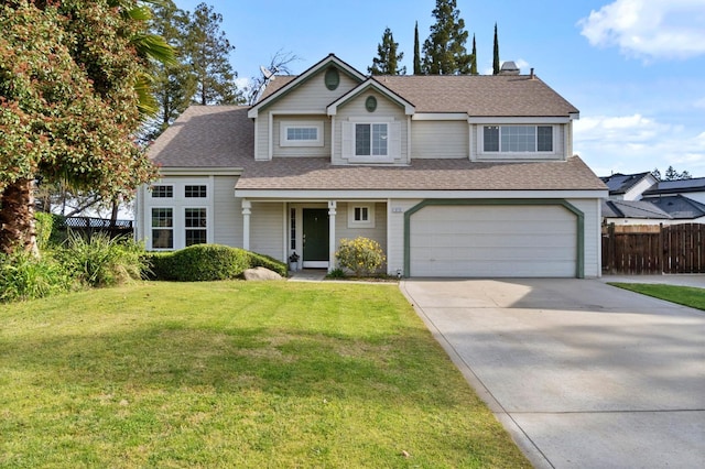 traditional-style house with a front lawn, fence, concrete driveway, a shingled roof, and a garage