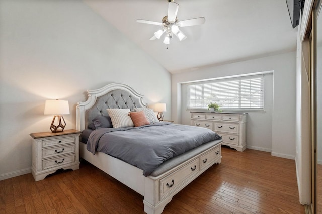 bedroom with hardwood / wood-style flooring, a ceiling fan, baseboards, and vaulted ceiling