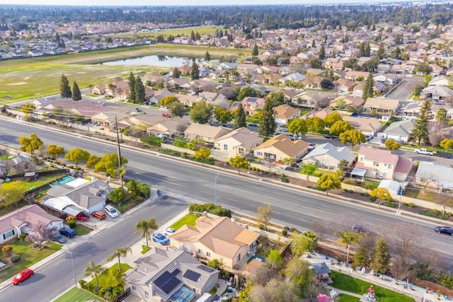 drone / aerial view featuring a residential view and a water view