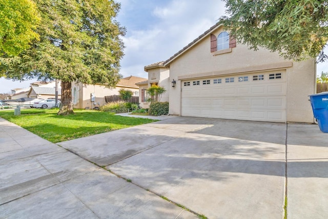 view of front facade with a front lawn, driveway, and stucco siding