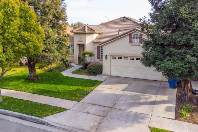 mediterranean / spanish home with driveway, an attached garage, stucco siding, a front lawn, and a tiled roof