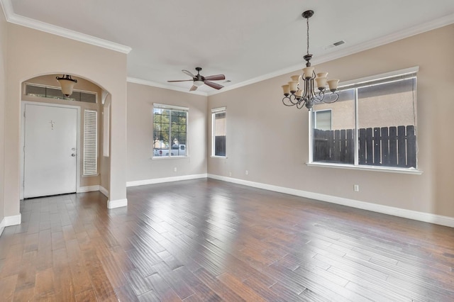 empty room featuring arched walkways, baseboards, and wood finished floors