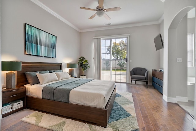 bedroom featuring access to exterior, crown molding, baseboards, and wood finished floors