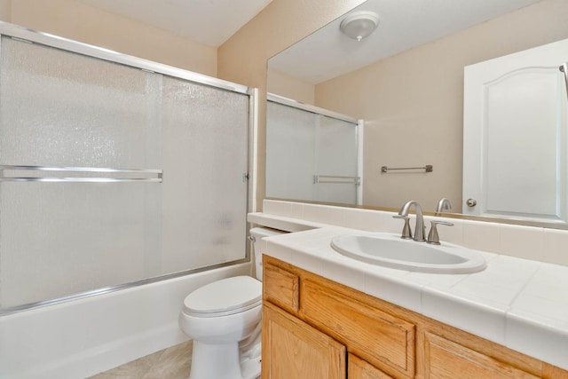 full bathroom with bath / shower combo with glass door, vanity, and toilet