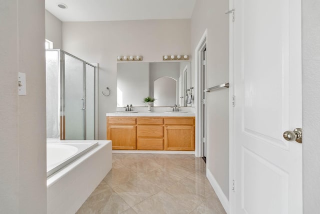 full bath with a shower stall, a bath, double vanity, and a sink