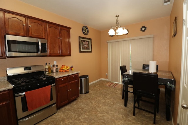 kitchen with baseboards, visible vents, an inviting chandelier, appliances with stainless steel finishes, and pendant lighting