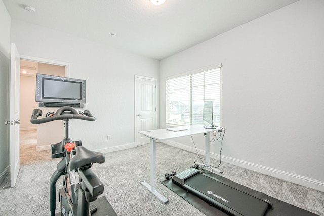 workout area with baseboards and carpet floors