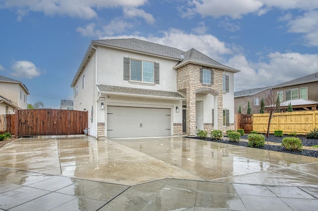 view of front of home with fence, driveway, stucco siding, a garage, and stone siding