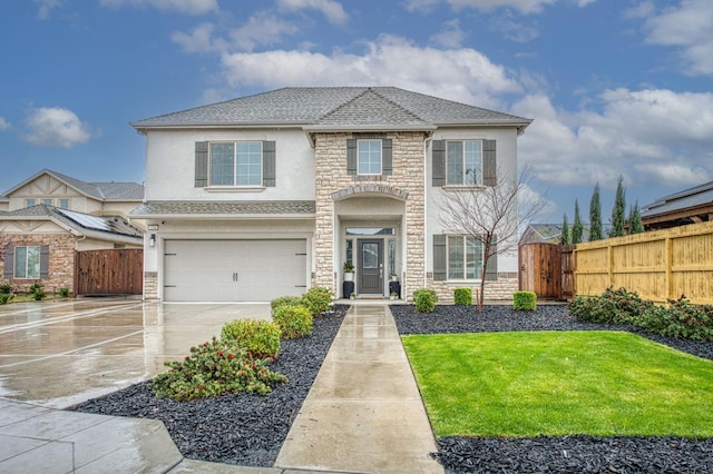 traditional home with fence, stucco siding, concrete driveway, a garage, and stone siding