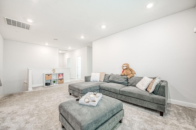 carpeted living area featuring recessed lighting, visible vents, and baseboards