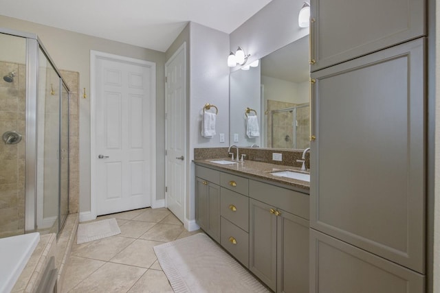 full bath with tile patterned flooring, a stall shower, double vanity, and a sink