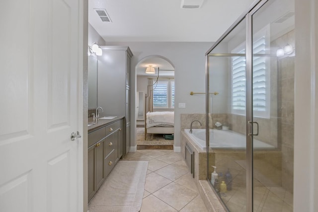 full bathroom featuring tile patterned flooring, a shower stall, vanity, and visible vents