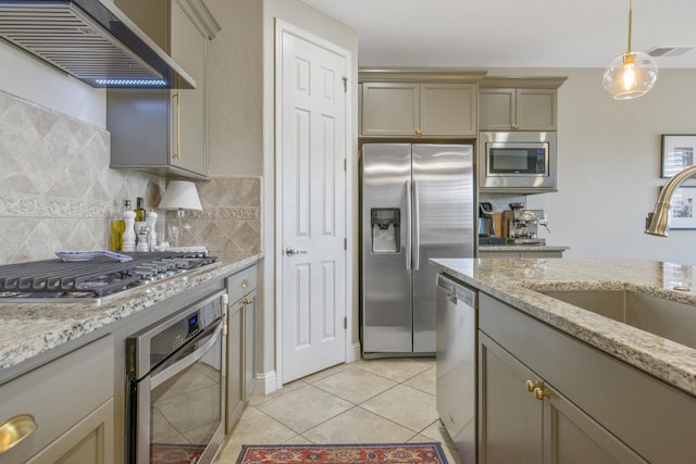 kitchen with visible vents, backsplash, ventilation hood, appliances with stainless steel finishes, and a sink