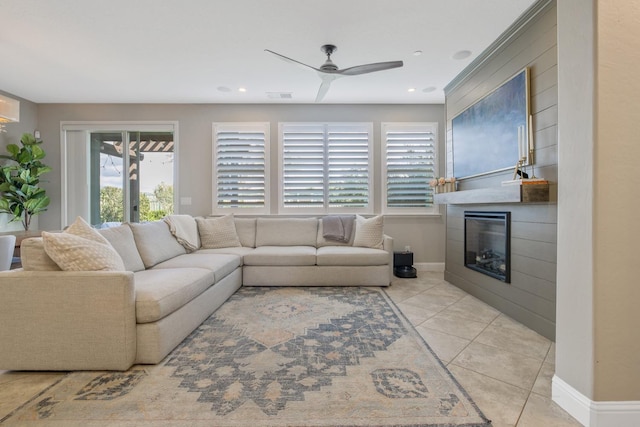 living room with visible vents, a large fireplace, ceiling fan, baseboards, and light tile patterned floors